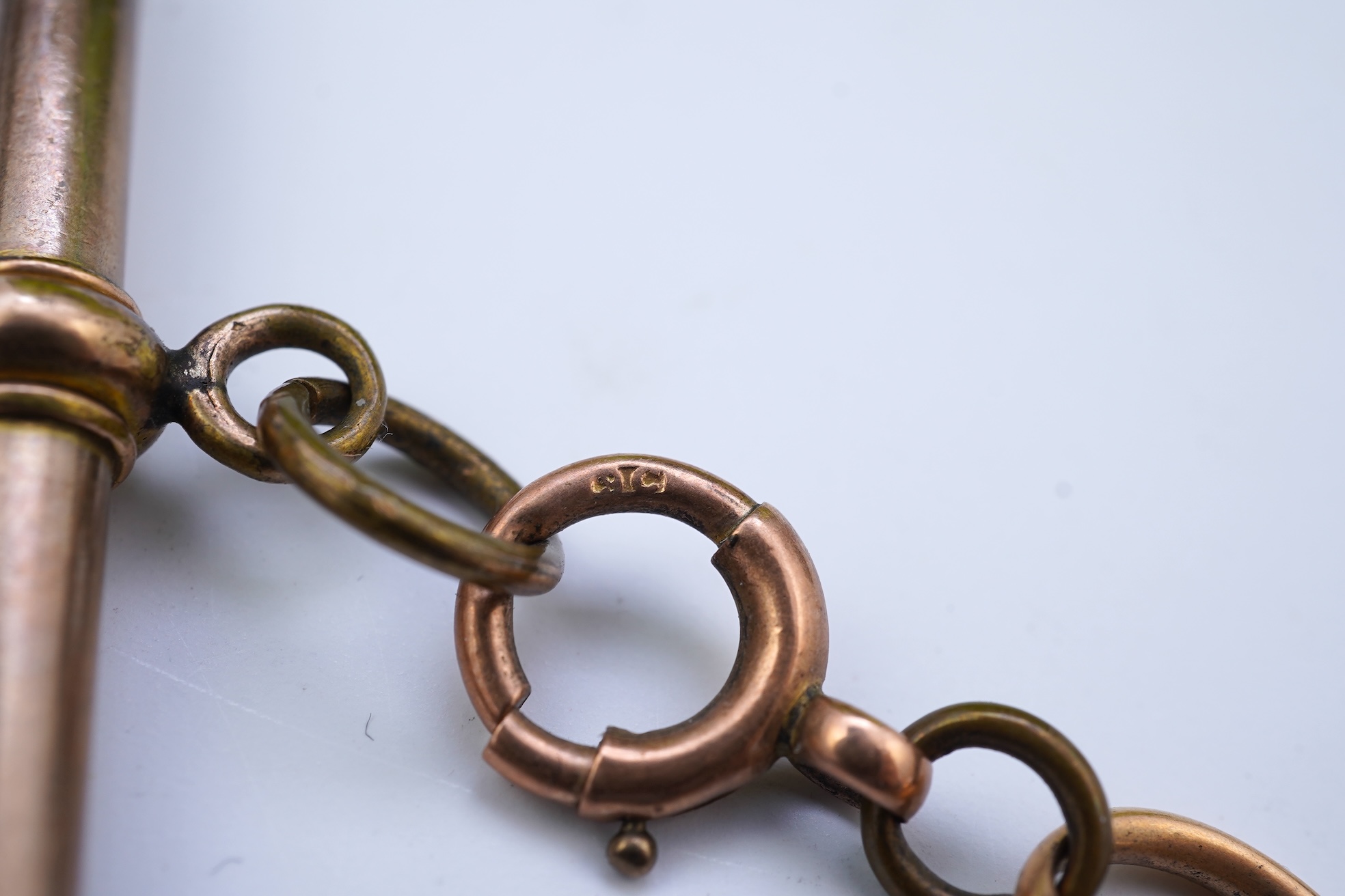 A continental 18k gold open faced keyless lever pocket watch, with a 9ct albert